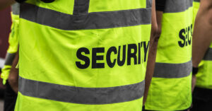 Two people wearing security vests